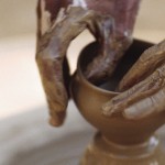 close-up of fingers throwing a pot